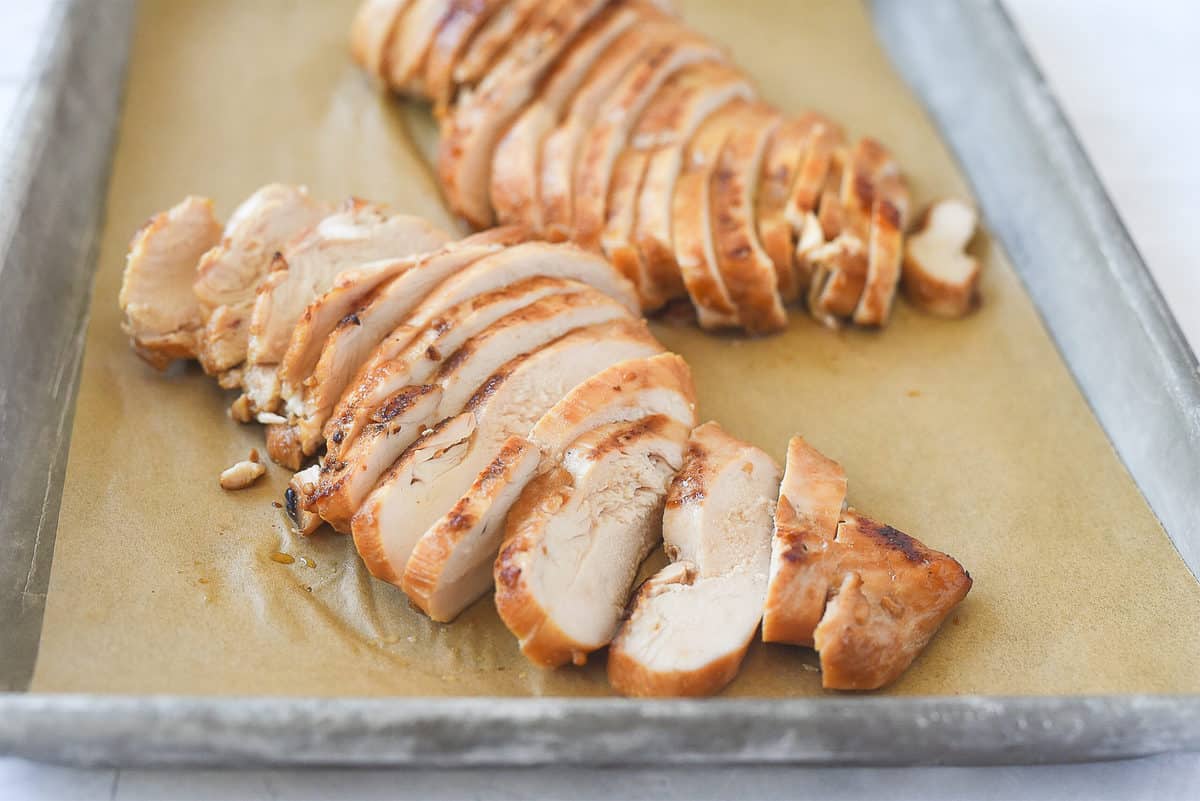 sliced chicken on a baking sheet