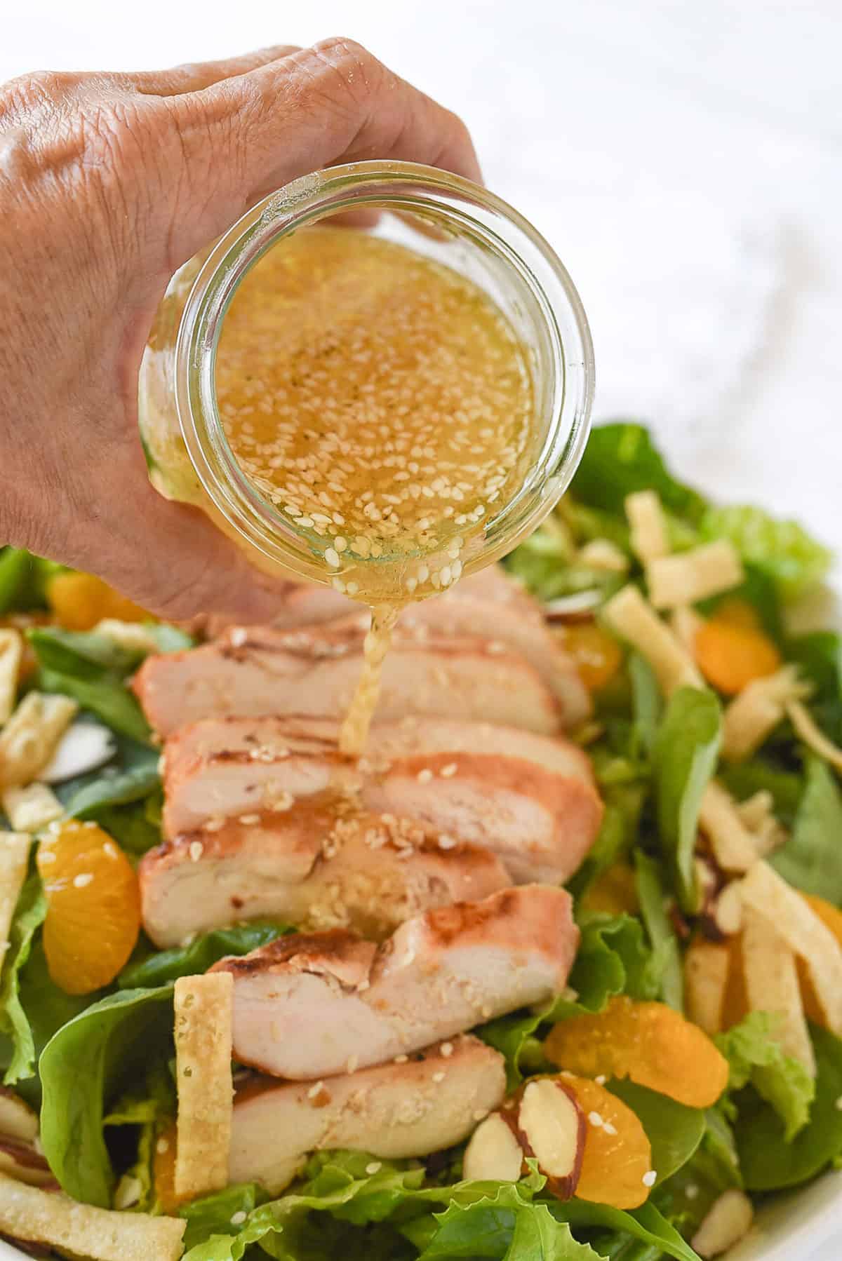 pouring dressing on salad