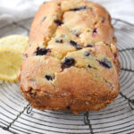 loaf of blueberry bread cooling on a rack