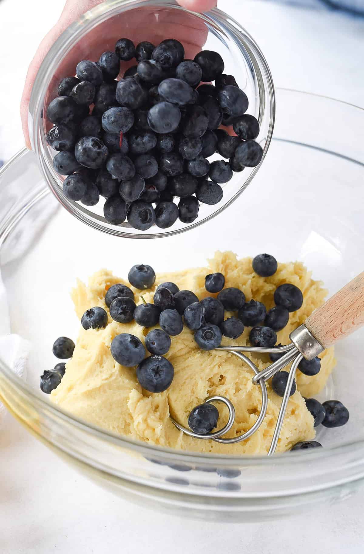 adding blueberries to bread batter