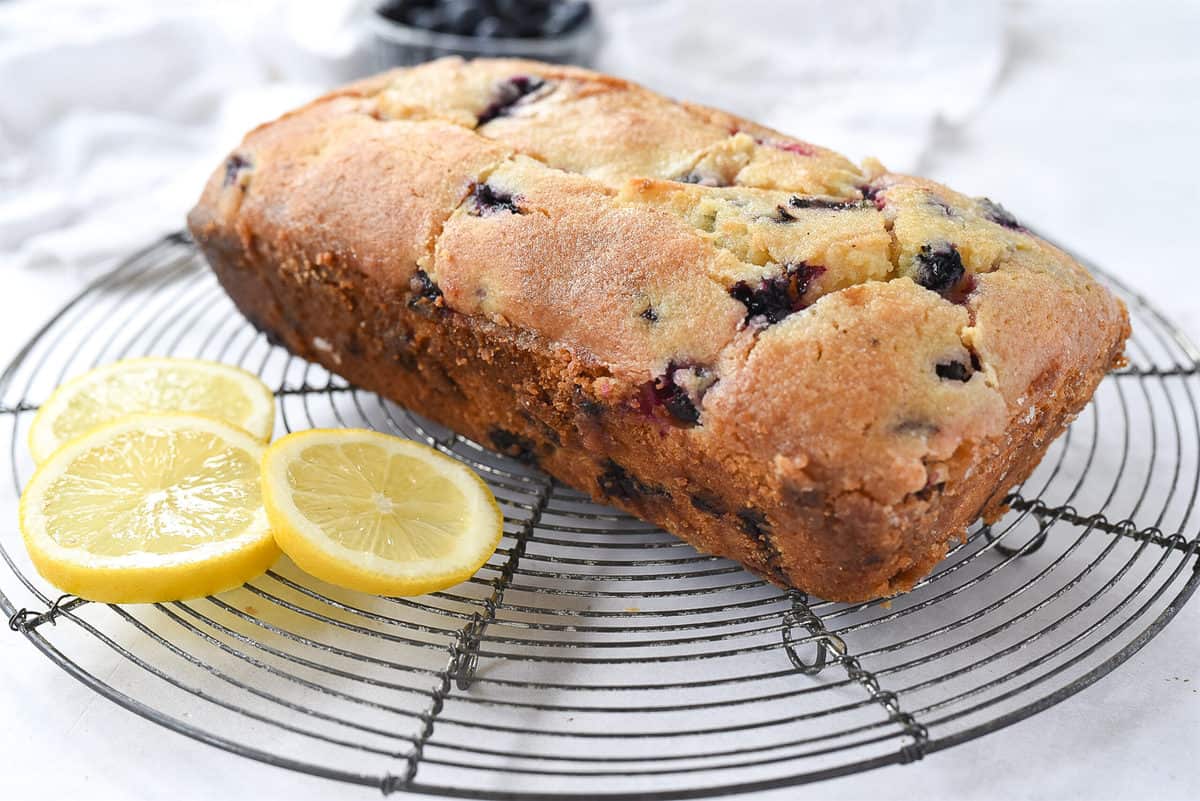 loaf of blueberry bread on cooling rack