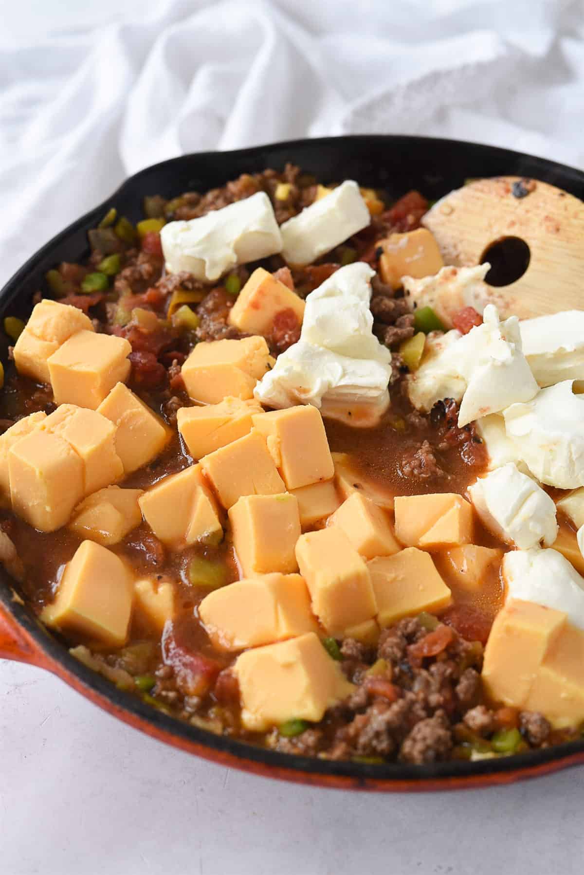 chunks of cheese melting in frying pan