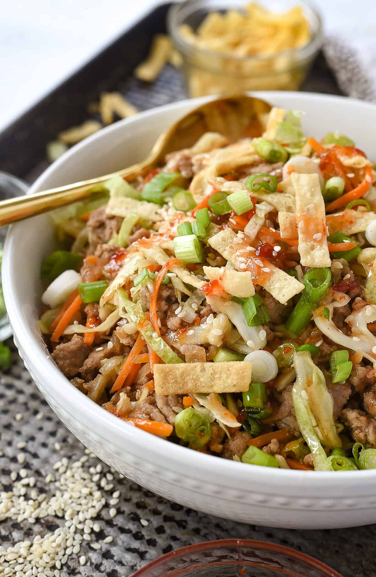 a white bowl full of eggroll in a bowl