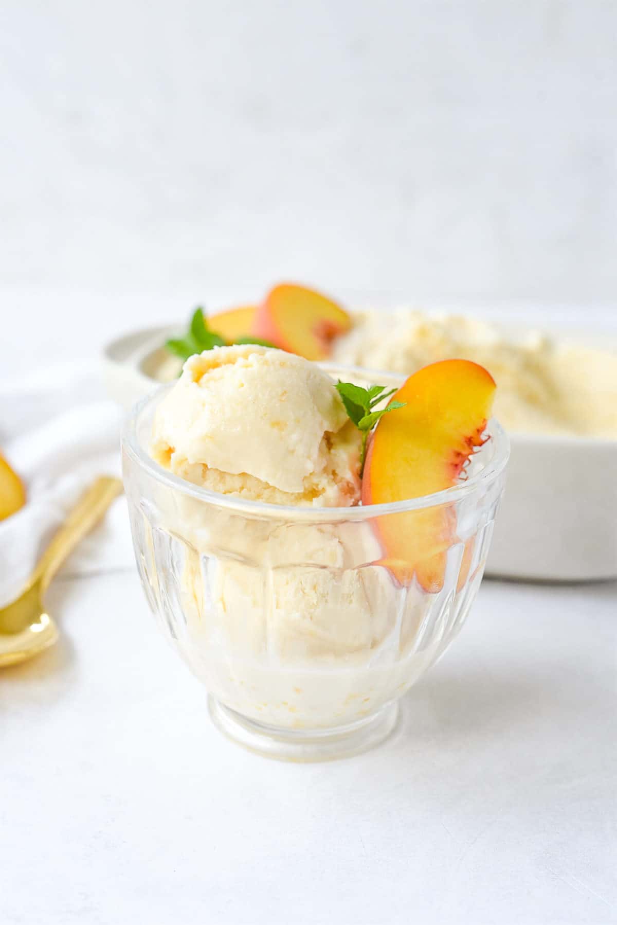 glass bowl of peach ice cream