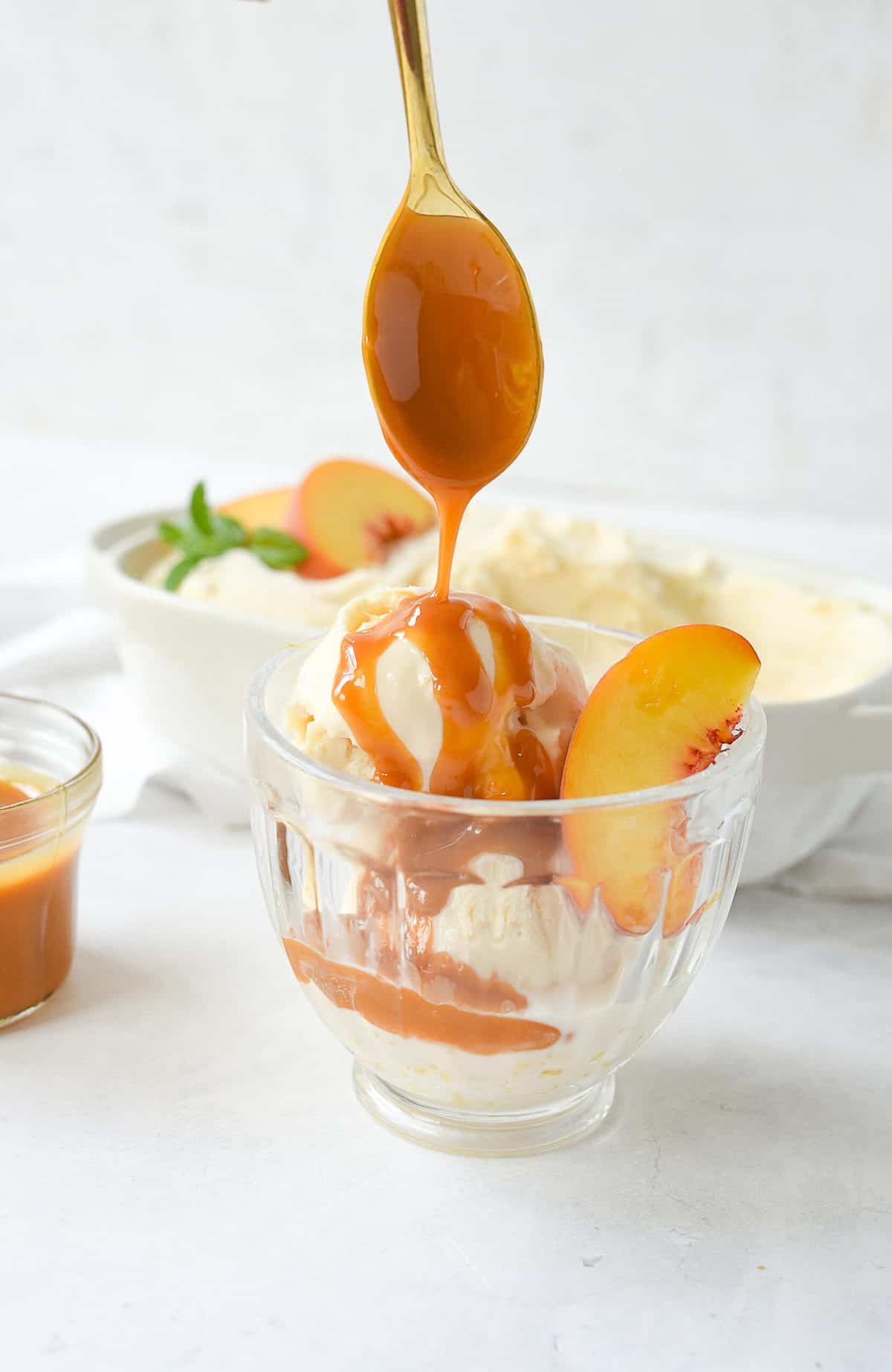 drizzling peach ice cream with caramel sauce