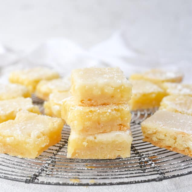 Stack of lemon bars on a cooling rack