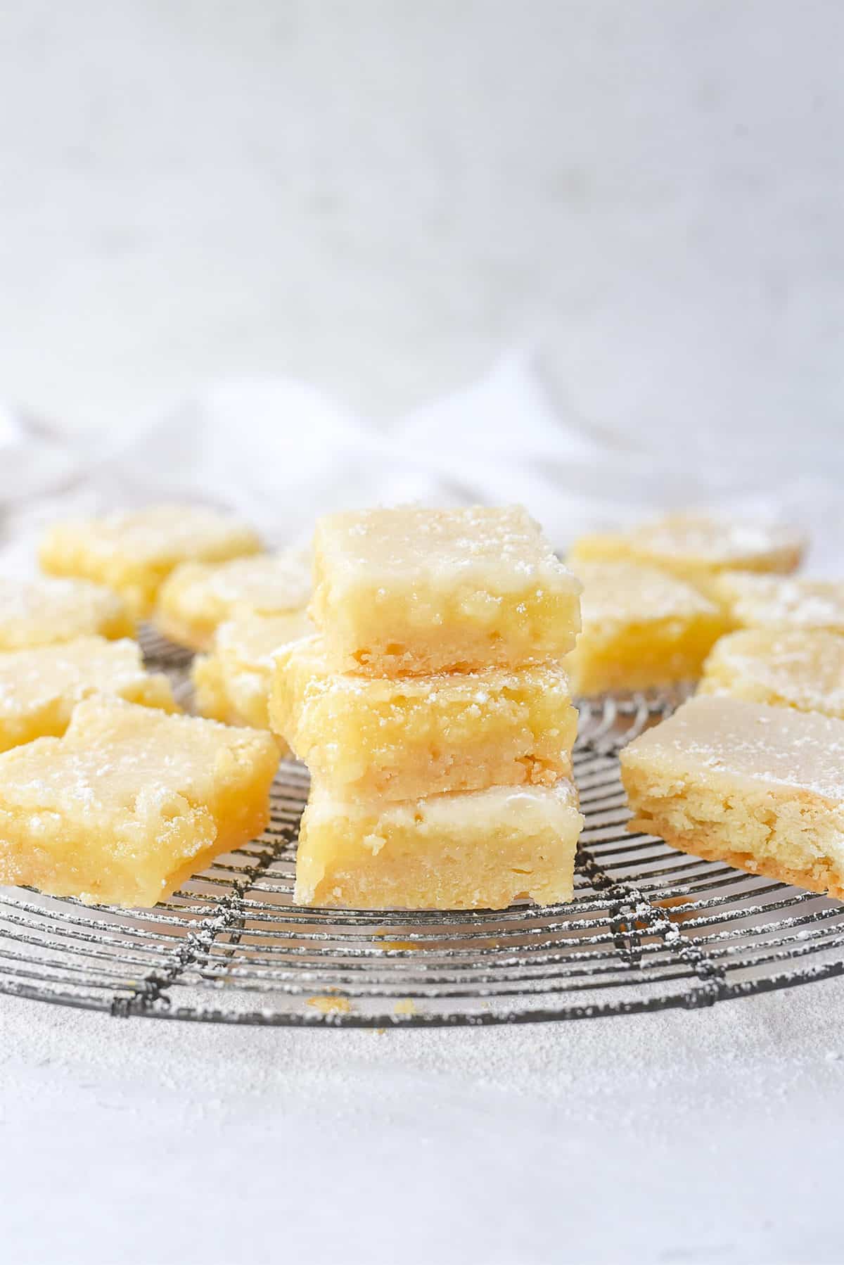 Stack of lemon bars on a cooling rack