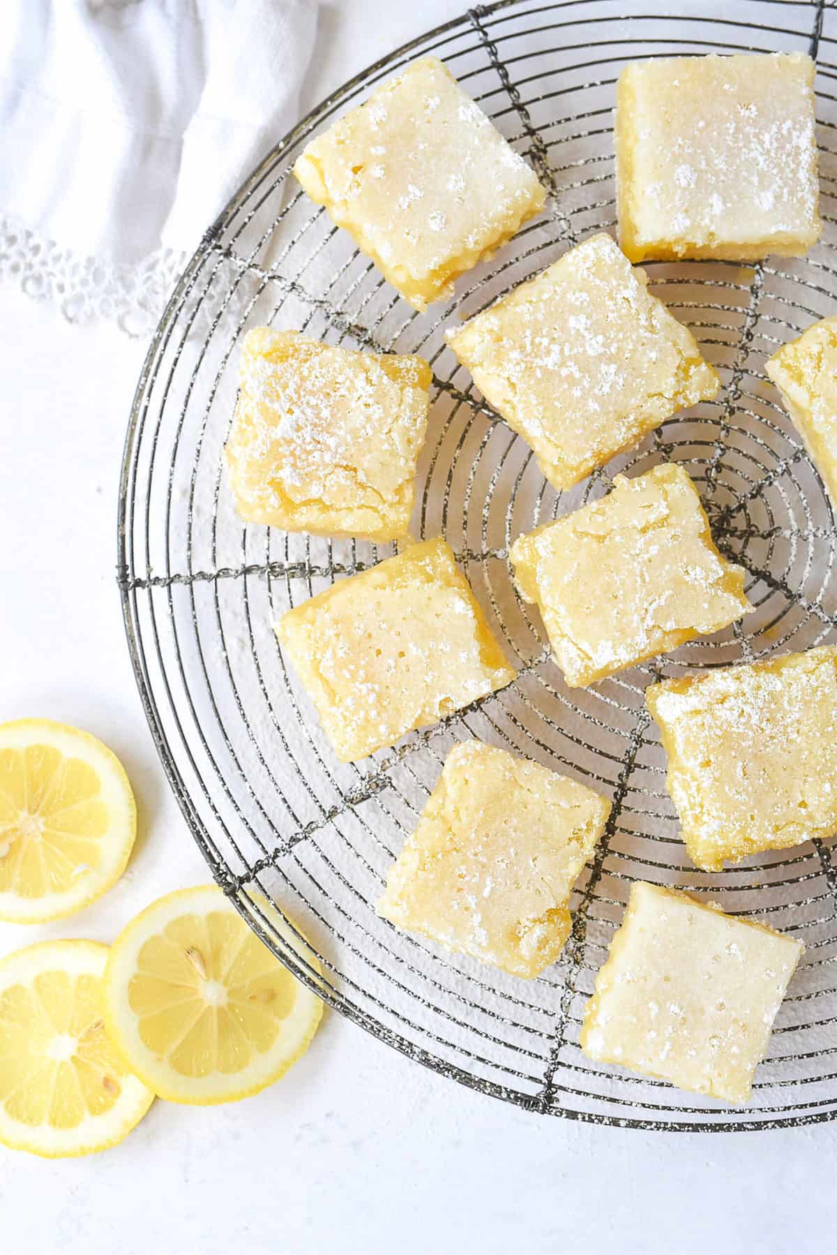 lemon bars on a cooling rack cut into squares