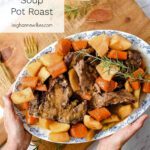 hands putting a platter of pot roast on a cutting board