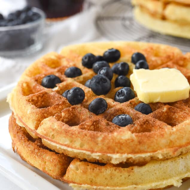 stack of two waffles with blueberries on top