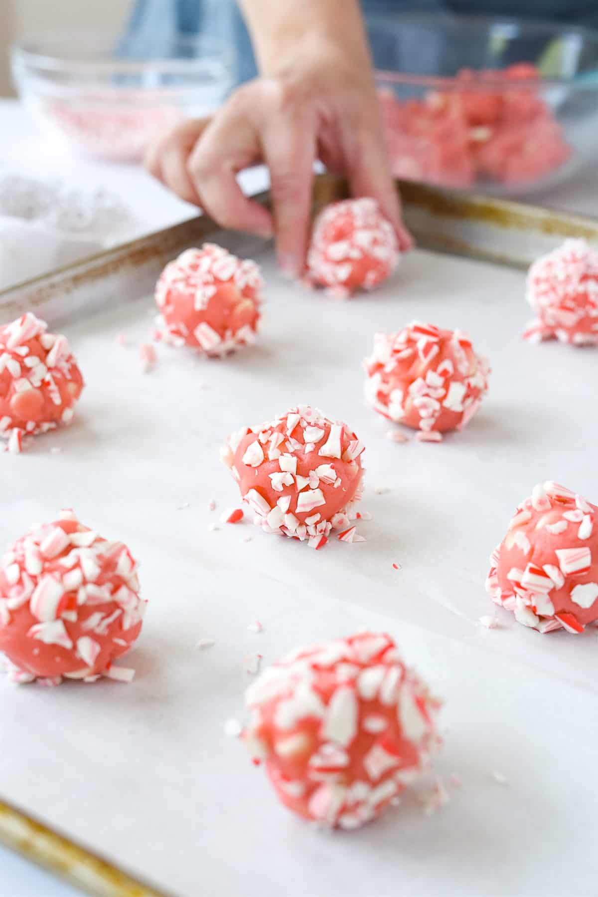 placing peppermint cookies on a baking sheet