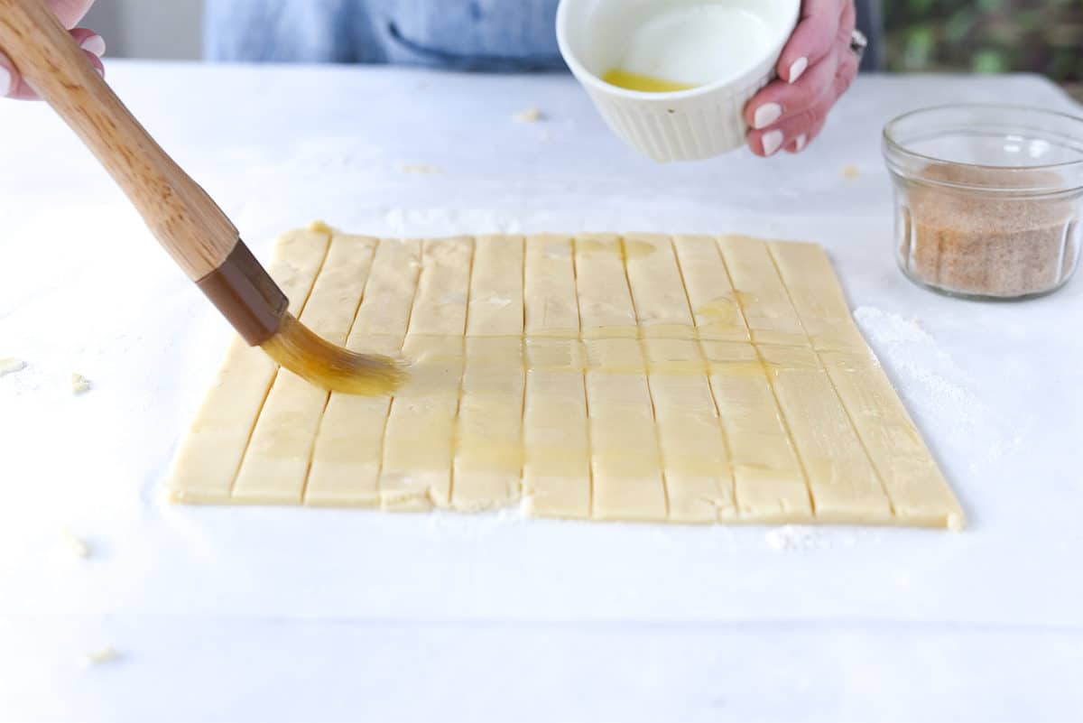 brushing pie dough with butter