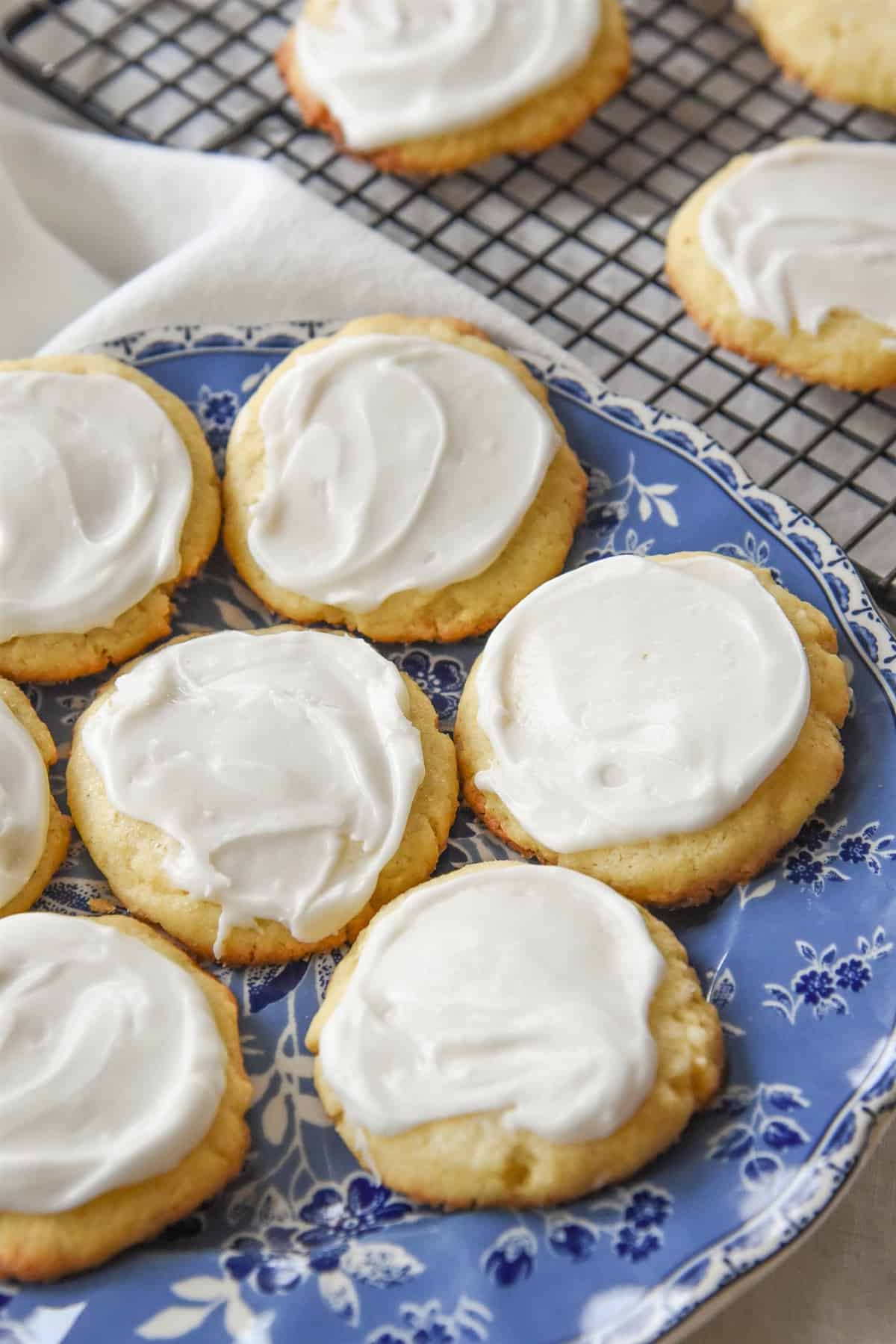 frosted almond meltaway cookies on a blue plate