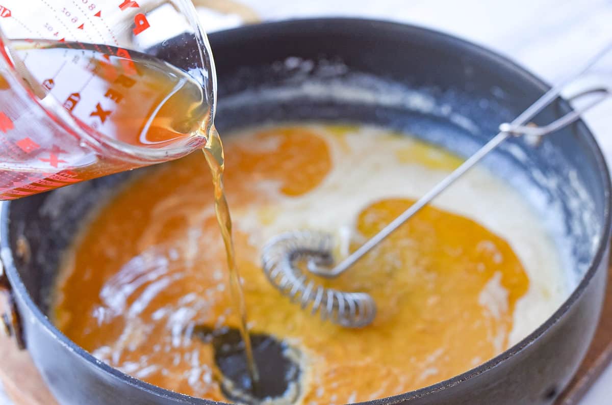pouring broth into gravy