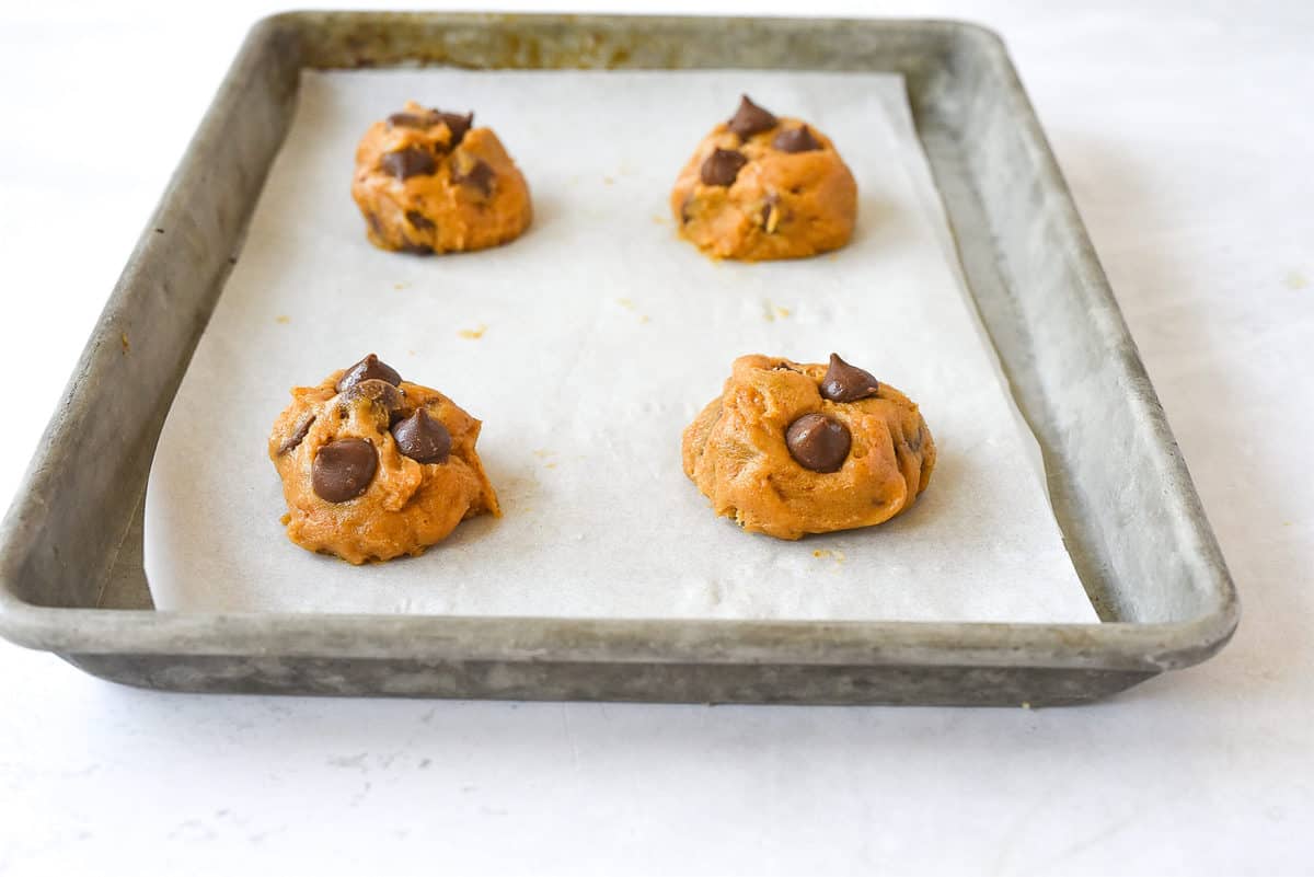 balls of pumpkin cookie dough on baking sheet