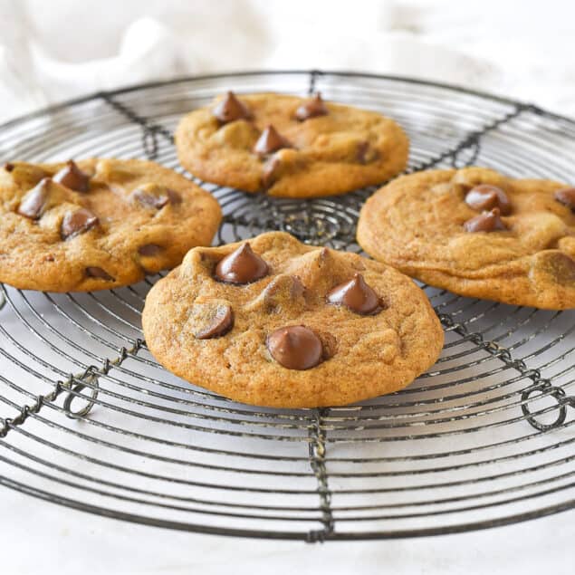 four pumpkin cookies with chocolate chips