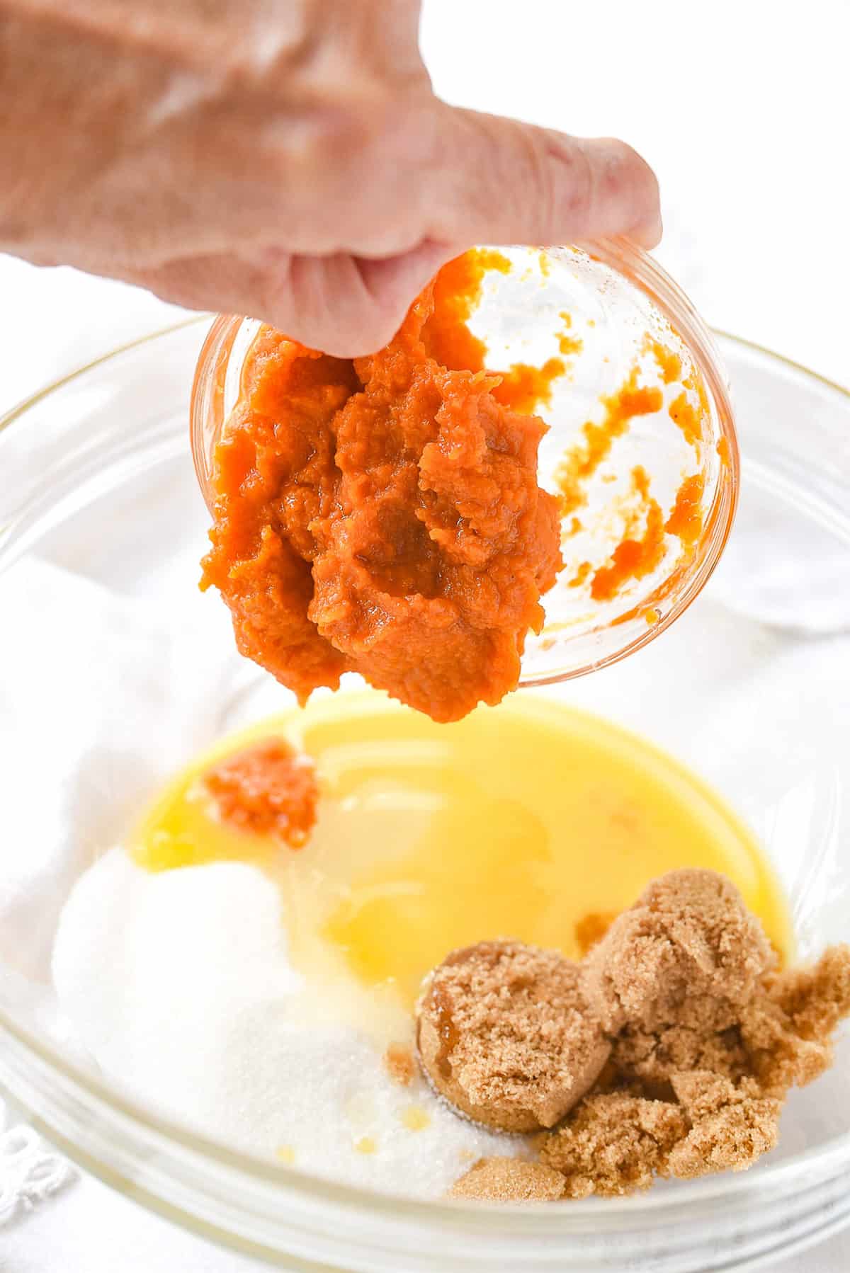 adding in pumpkin puree to the muffins