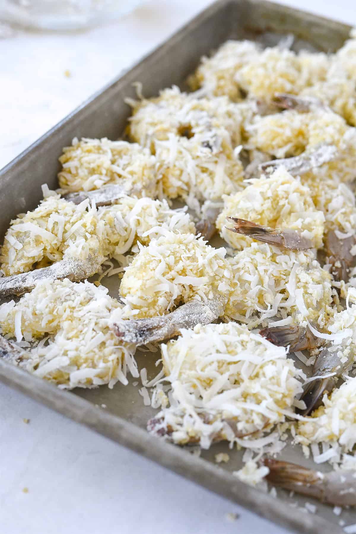 coconut shrimp on a baking sheet