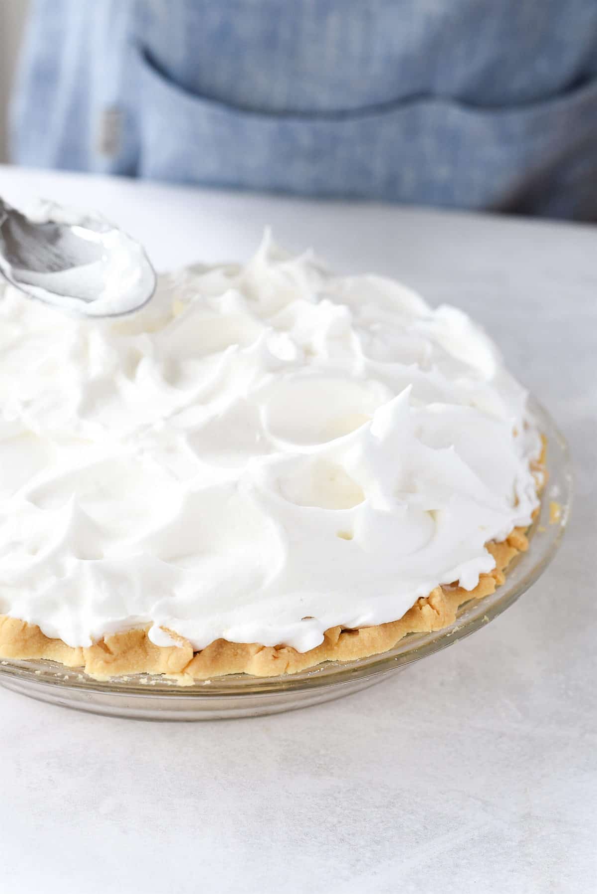 smoothing meringue on chocolate pie