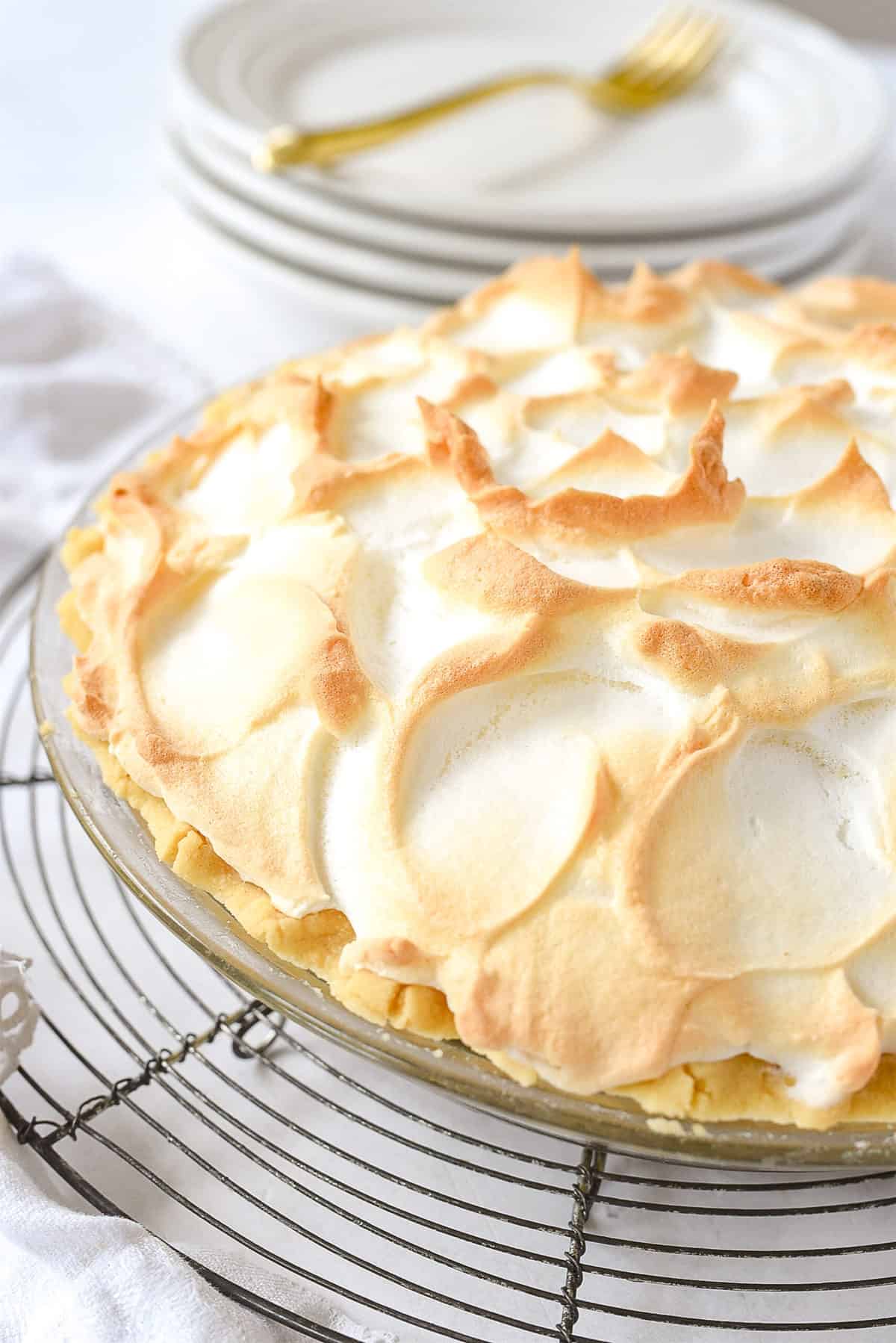 meringue topped pie on cooling rack