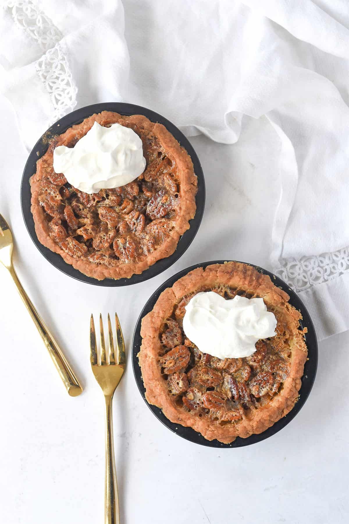 overhead shot of two small pecan piees