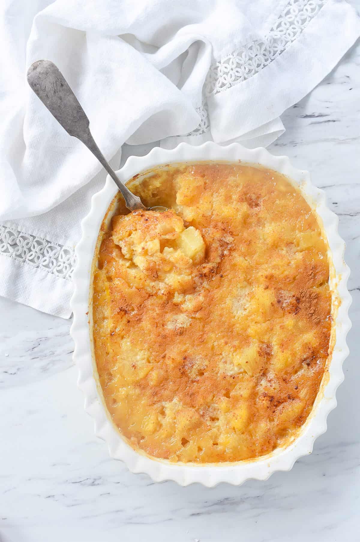 spoon in a dish of pineapple casserole