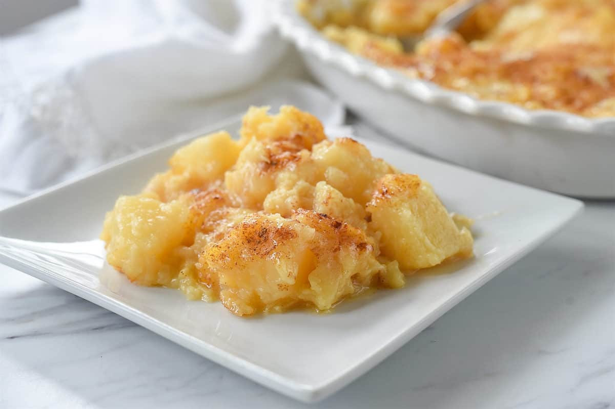 plate with a scoop of pineapple casserole on top