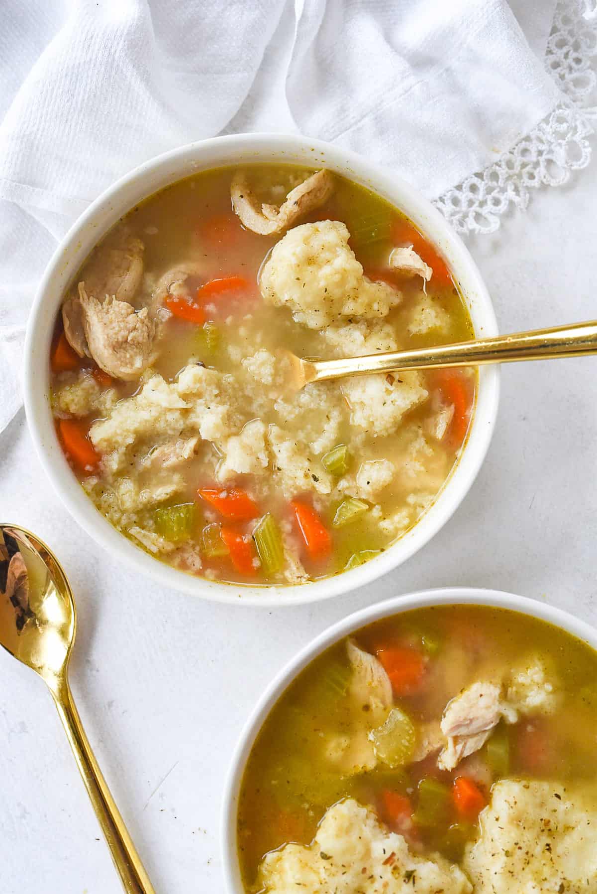 spoon in a bowl of chicken and dumplings