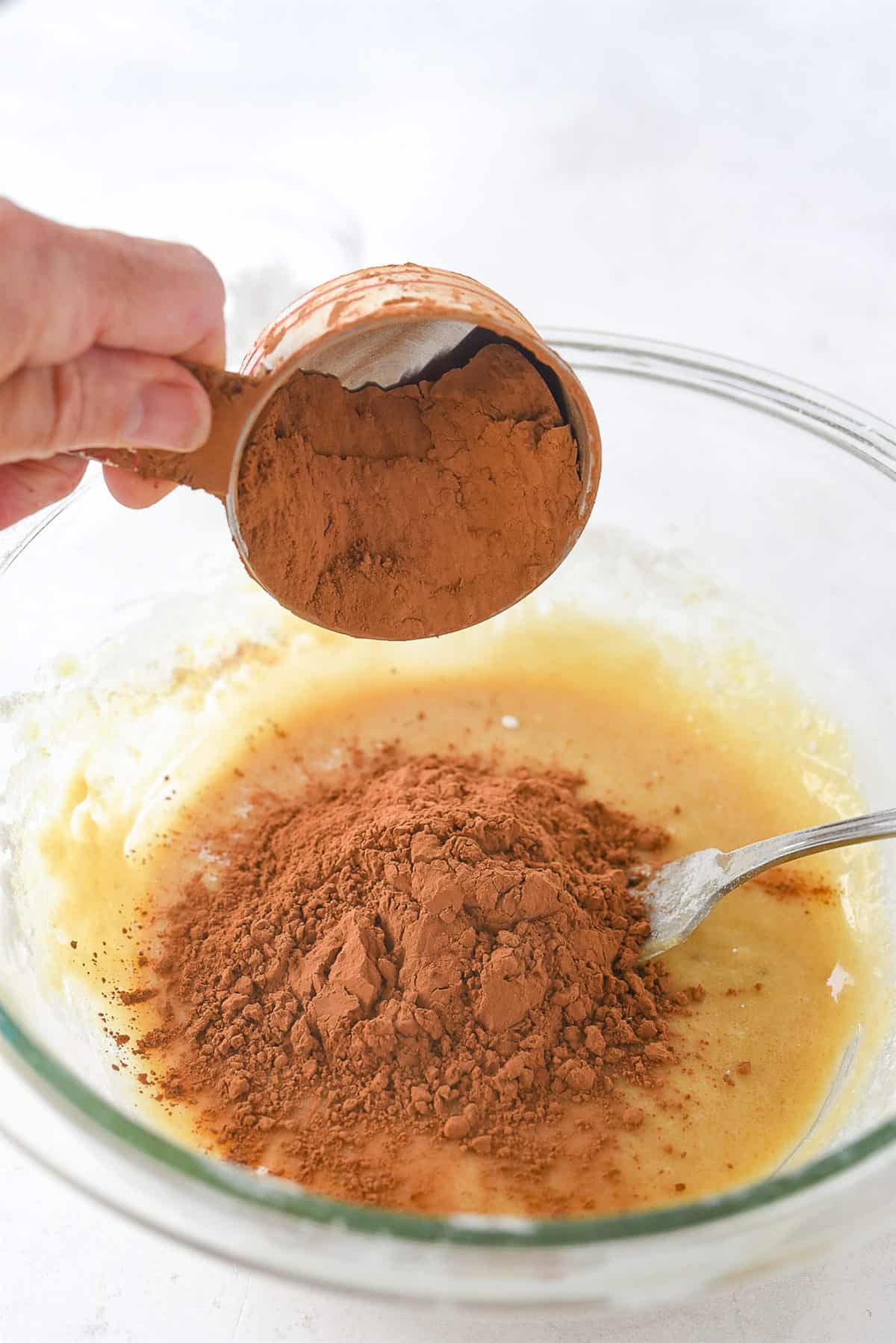 adding cocoa to cookie dough