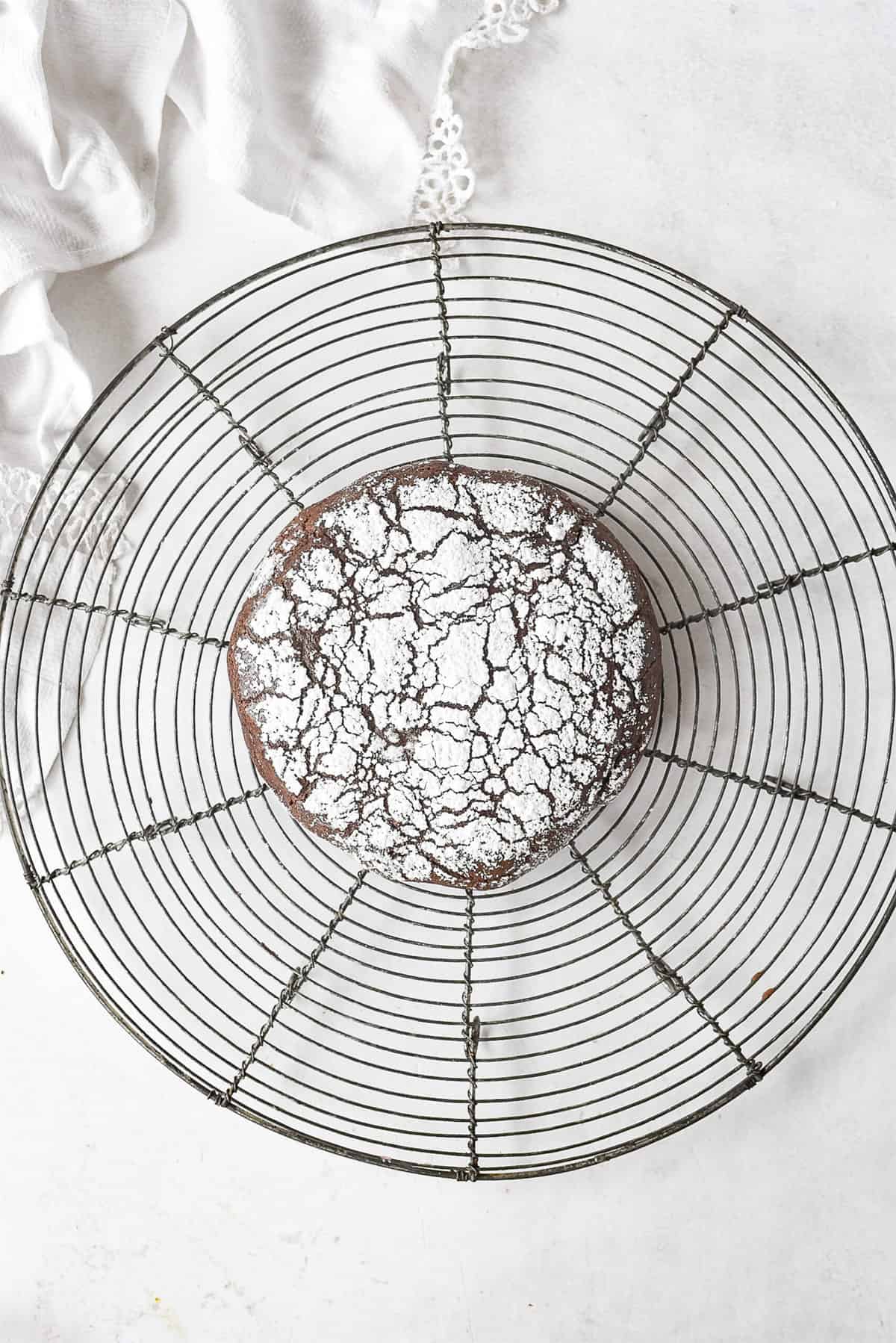 giant chocolate crinkle cookie on a cooling rack
