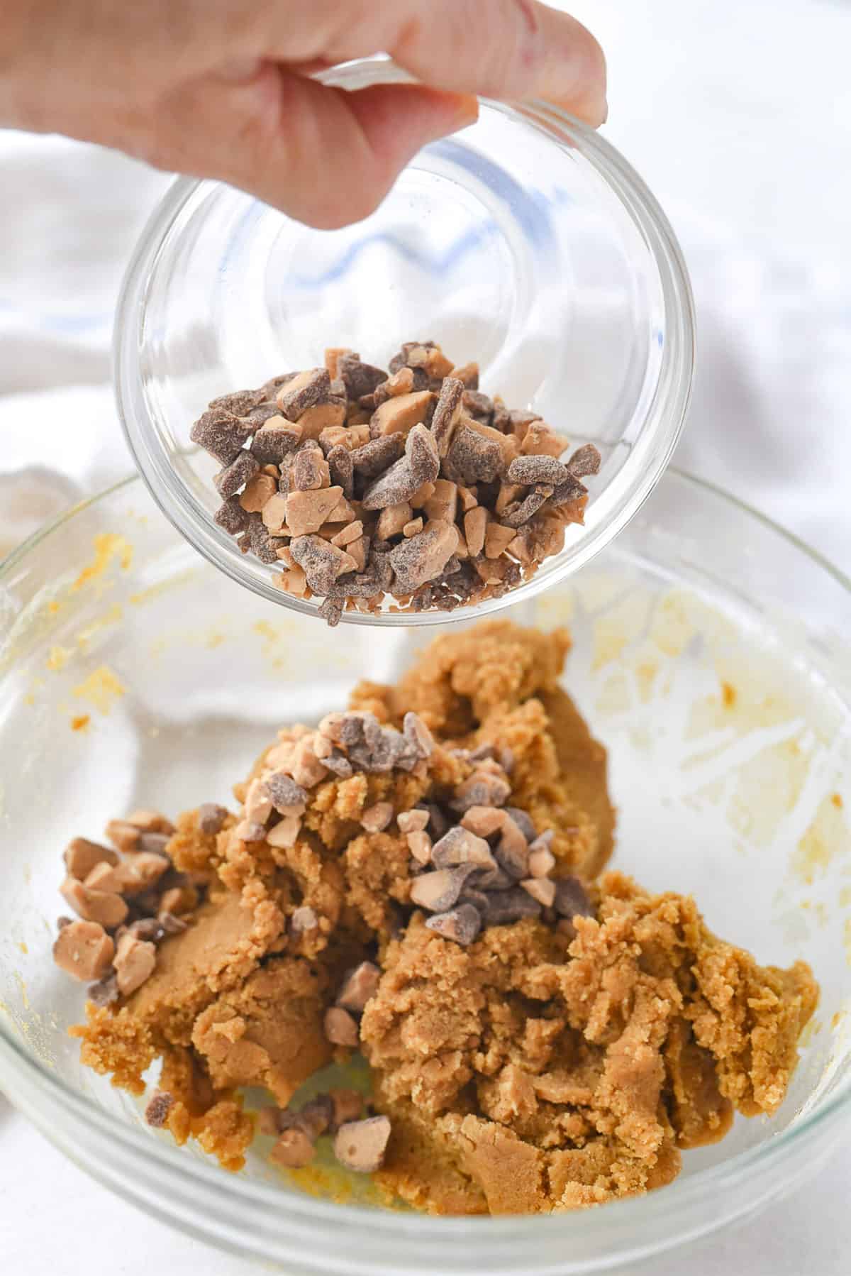adding toffee bits to cookie dough
