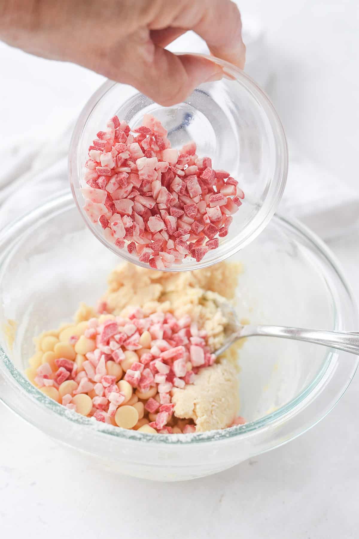 adding peppermint chips into cookie dough