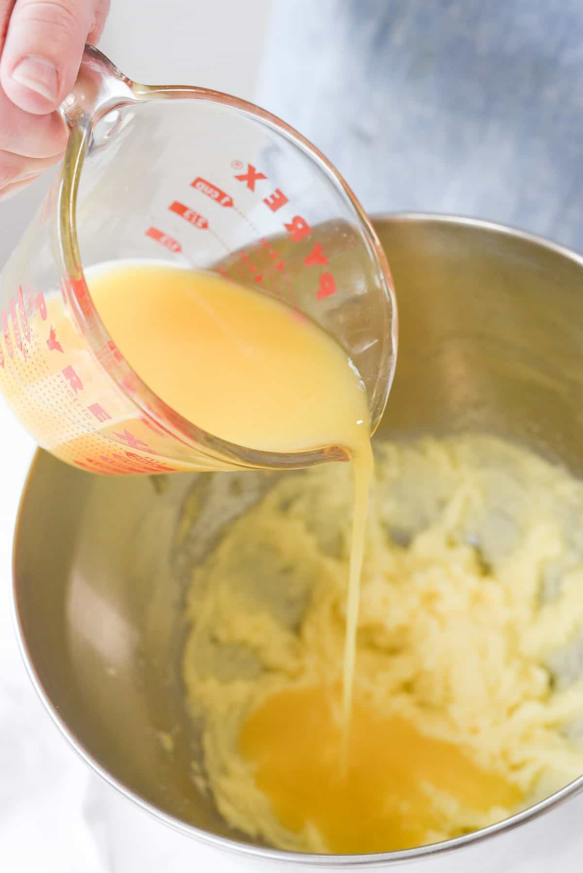 pouring orange juice into bowl