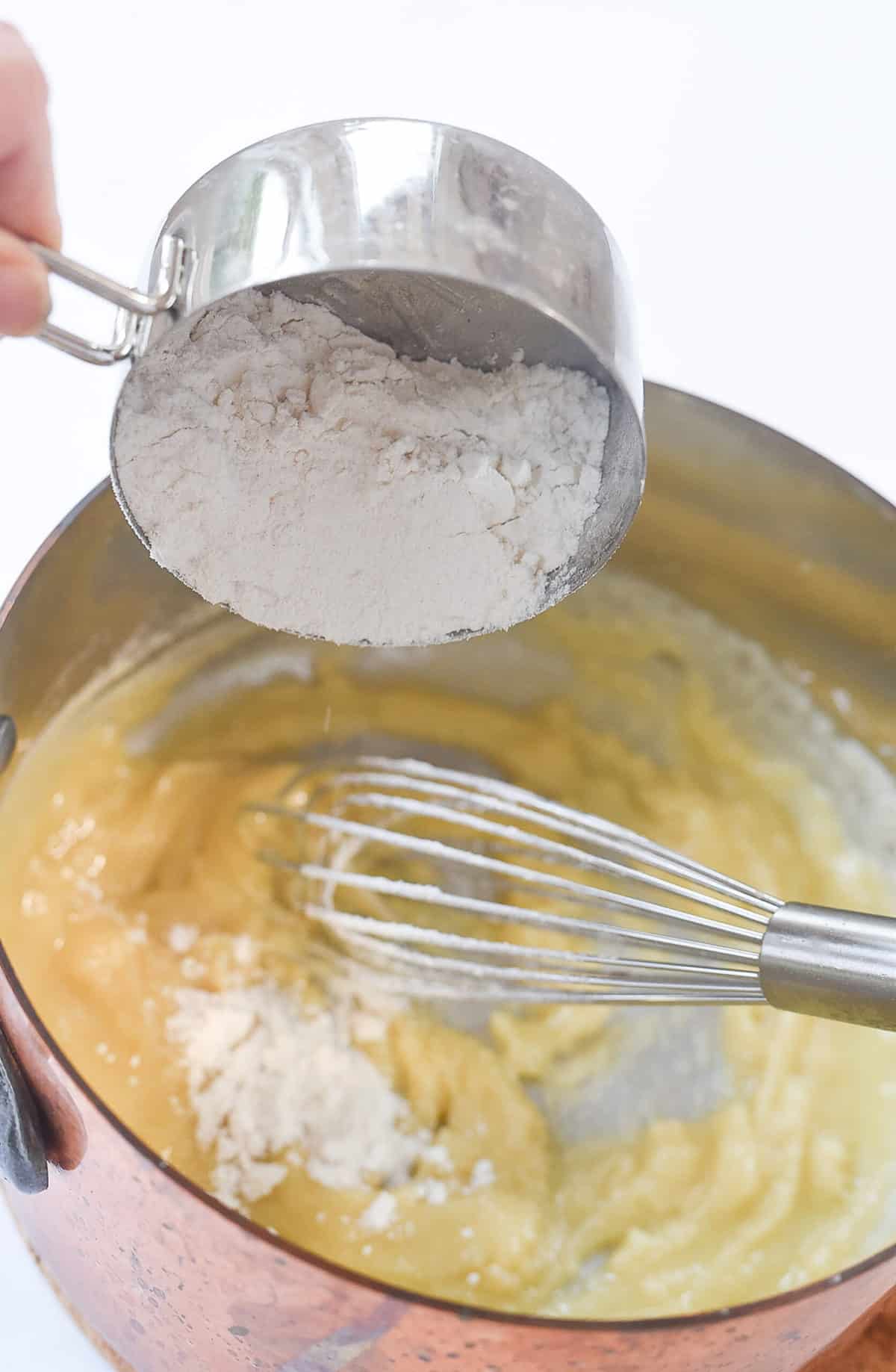 adding flour to a pan