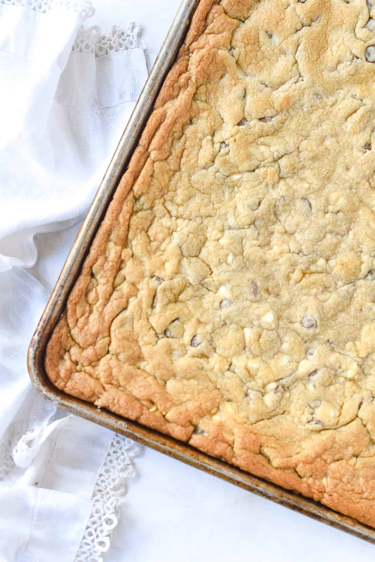 uncut chocolate chip cookie bars in a pan.