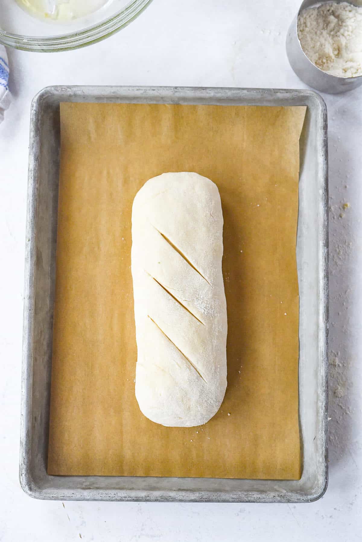 bread rising on baking sheet