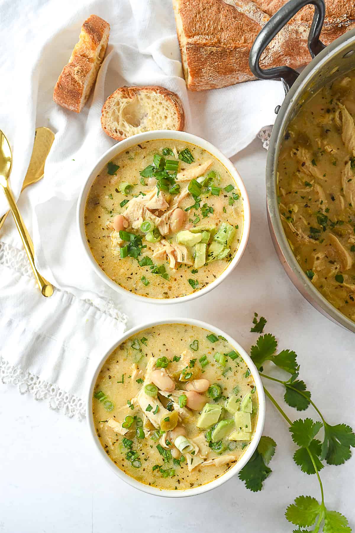 overhead shot of white chicken chili with toppings