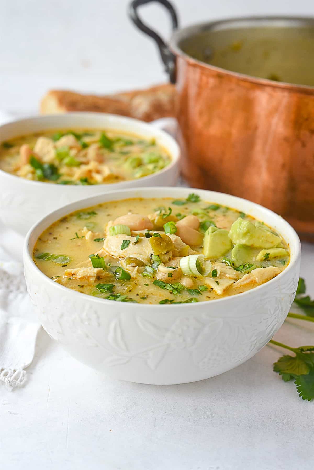 white bowls of chicken chili