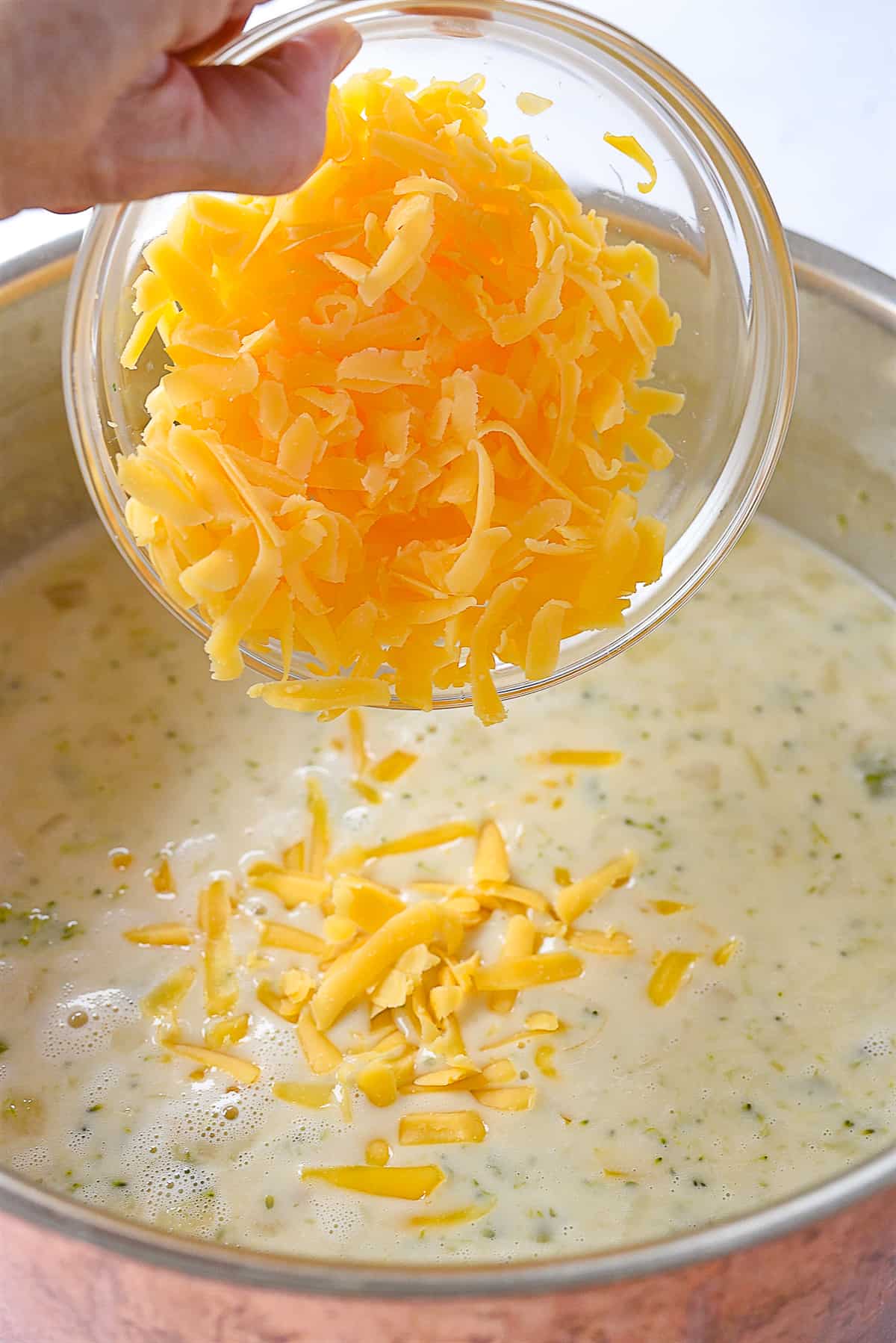 adding cheese to soup