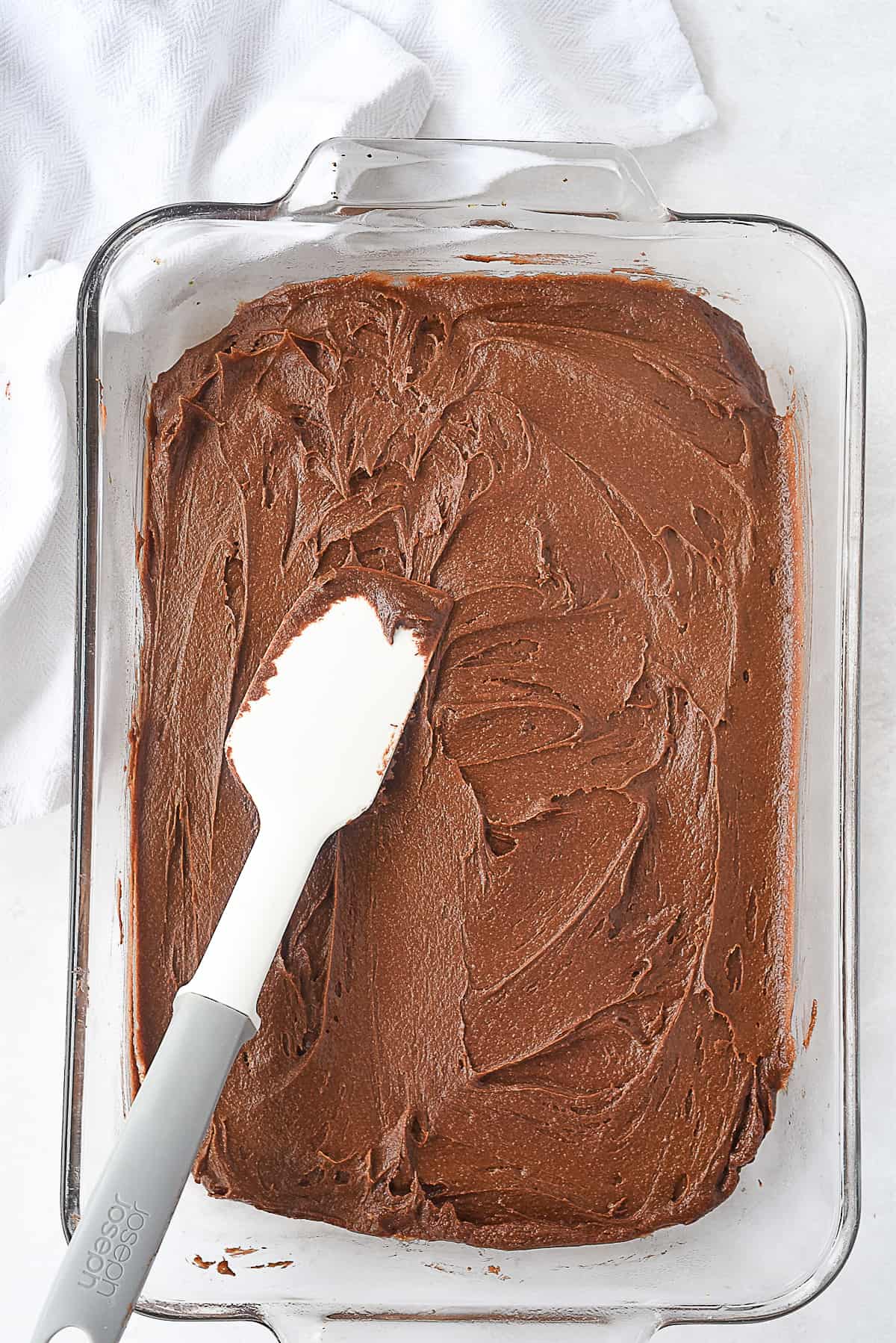 spreading brownie in pan.