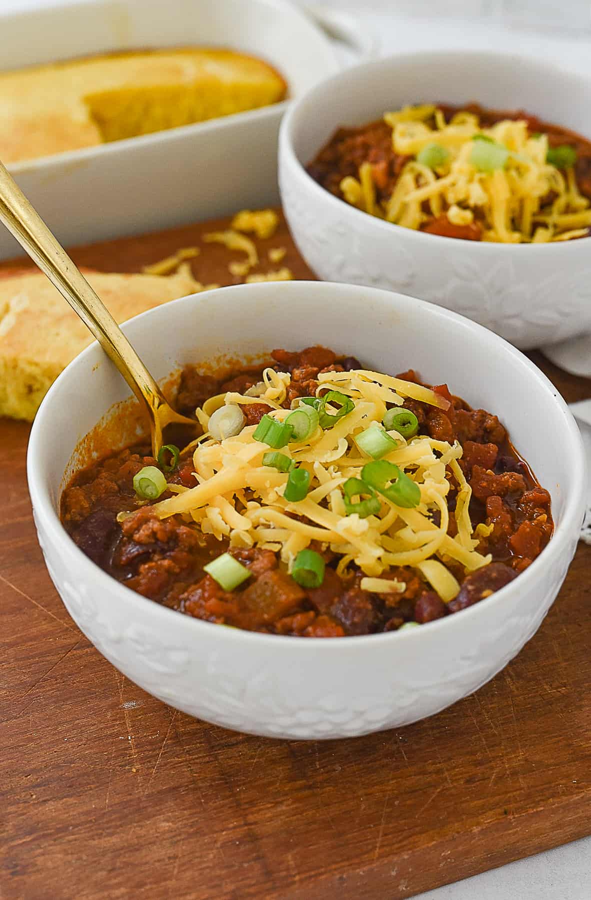 a bowl of chili with a spoon in it