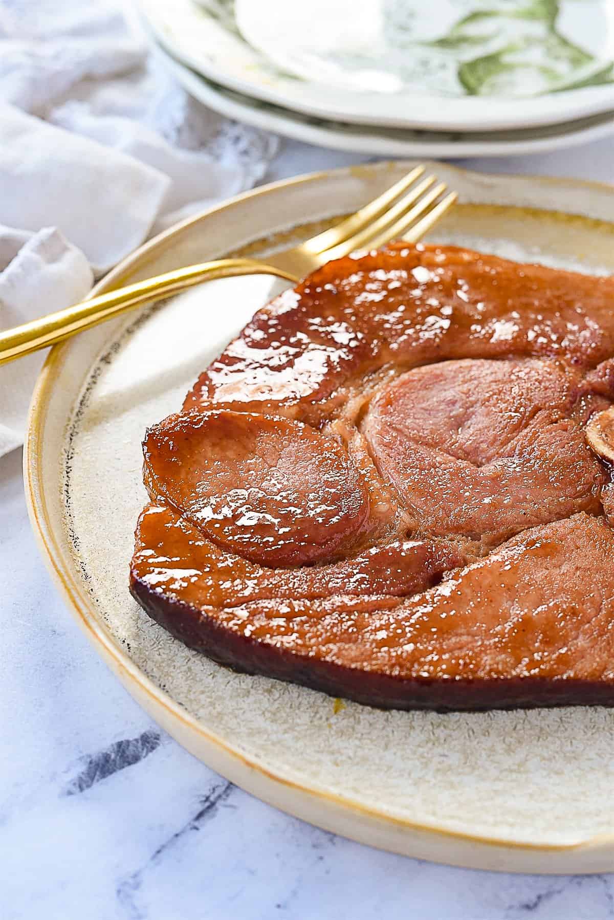 ham steak on a plate with a fork