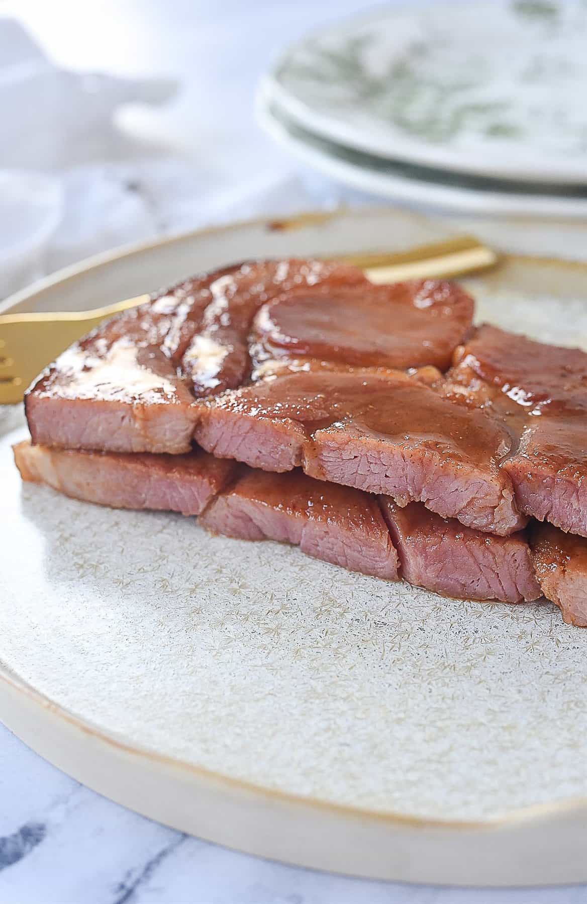 ham sliced in half on plate