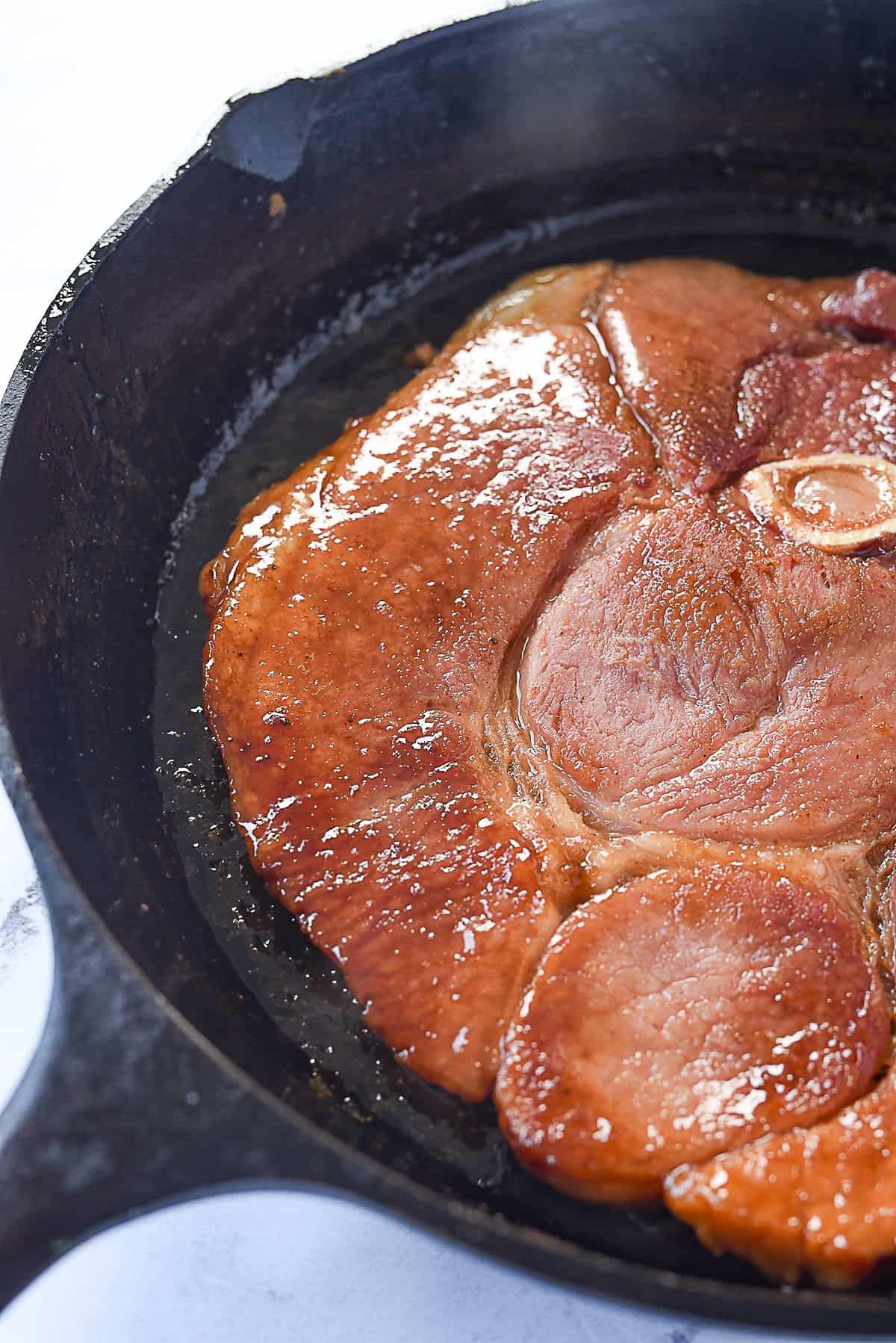 glazed ham steak in a pan