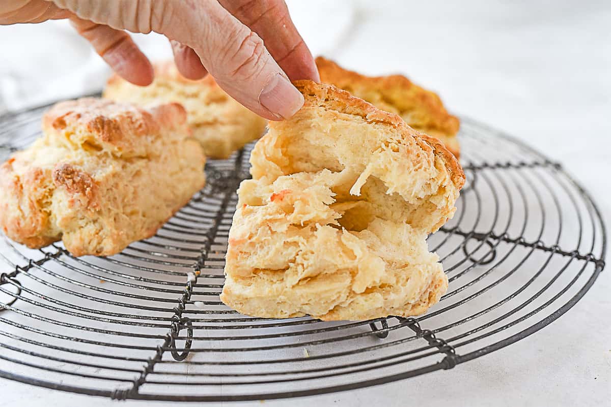 hand opening up a biscuits