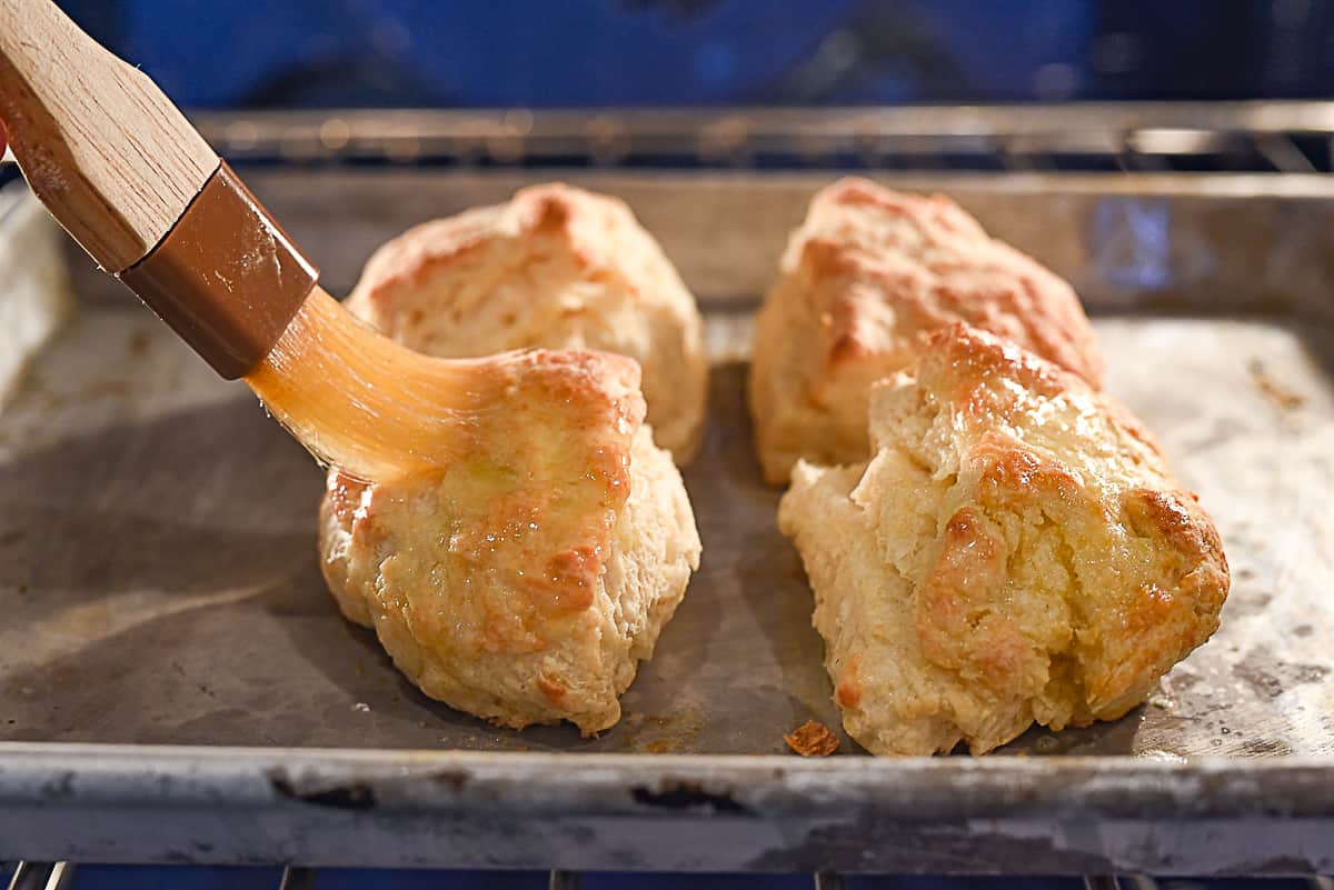 brushing biscuits with melted butter