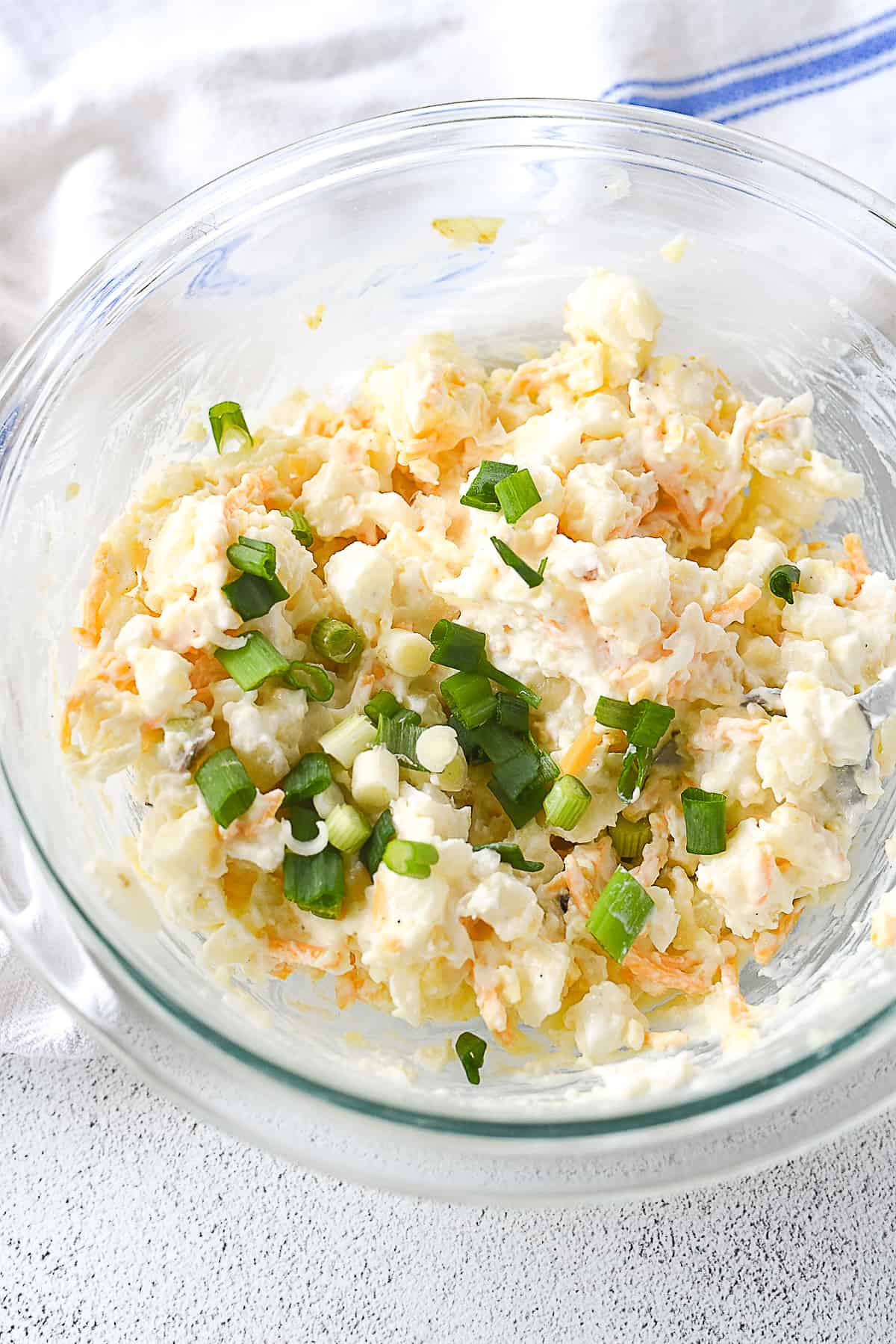 bowl of unbaked cheesy potatoes