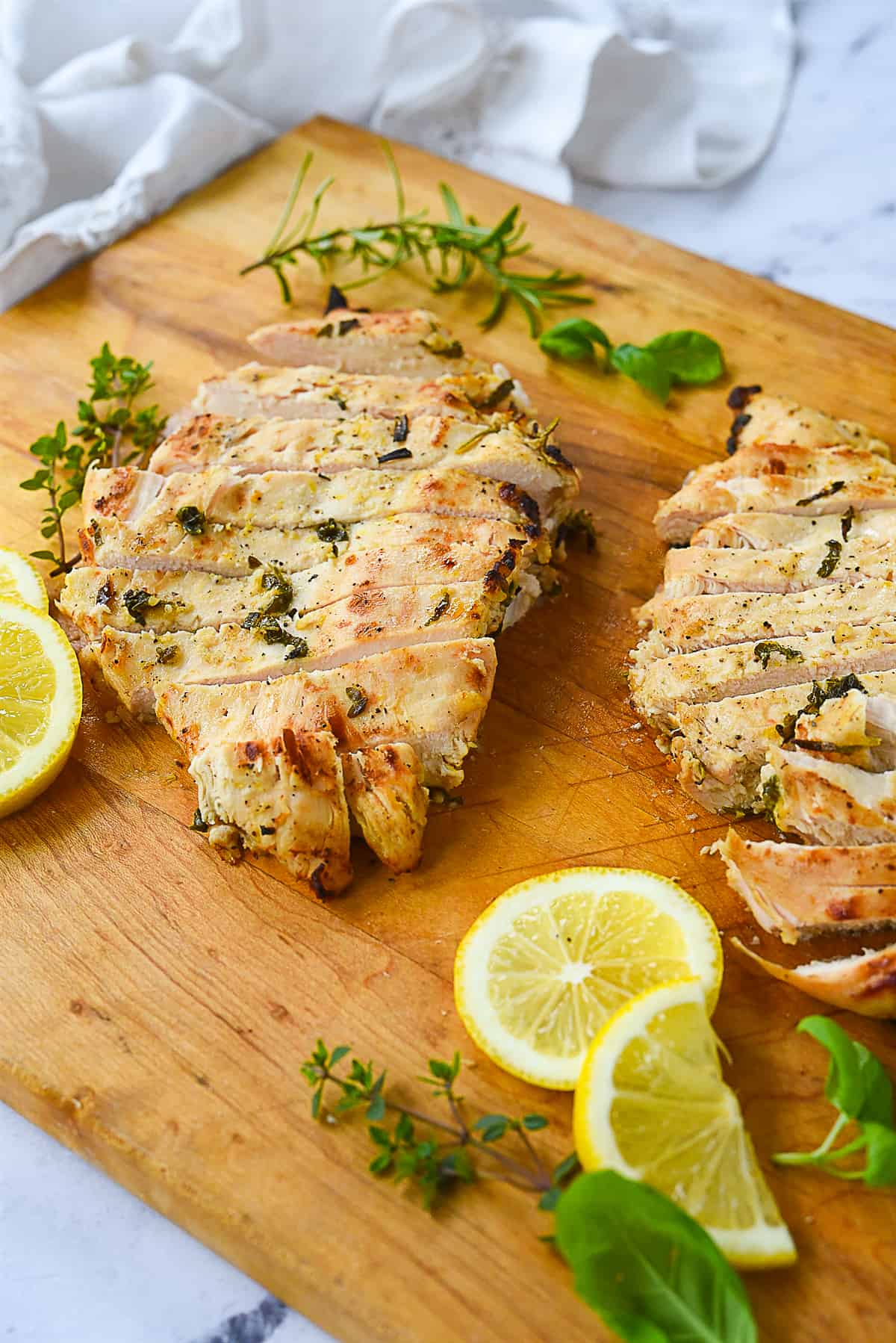 two sliced chicken breasts on a cutting board