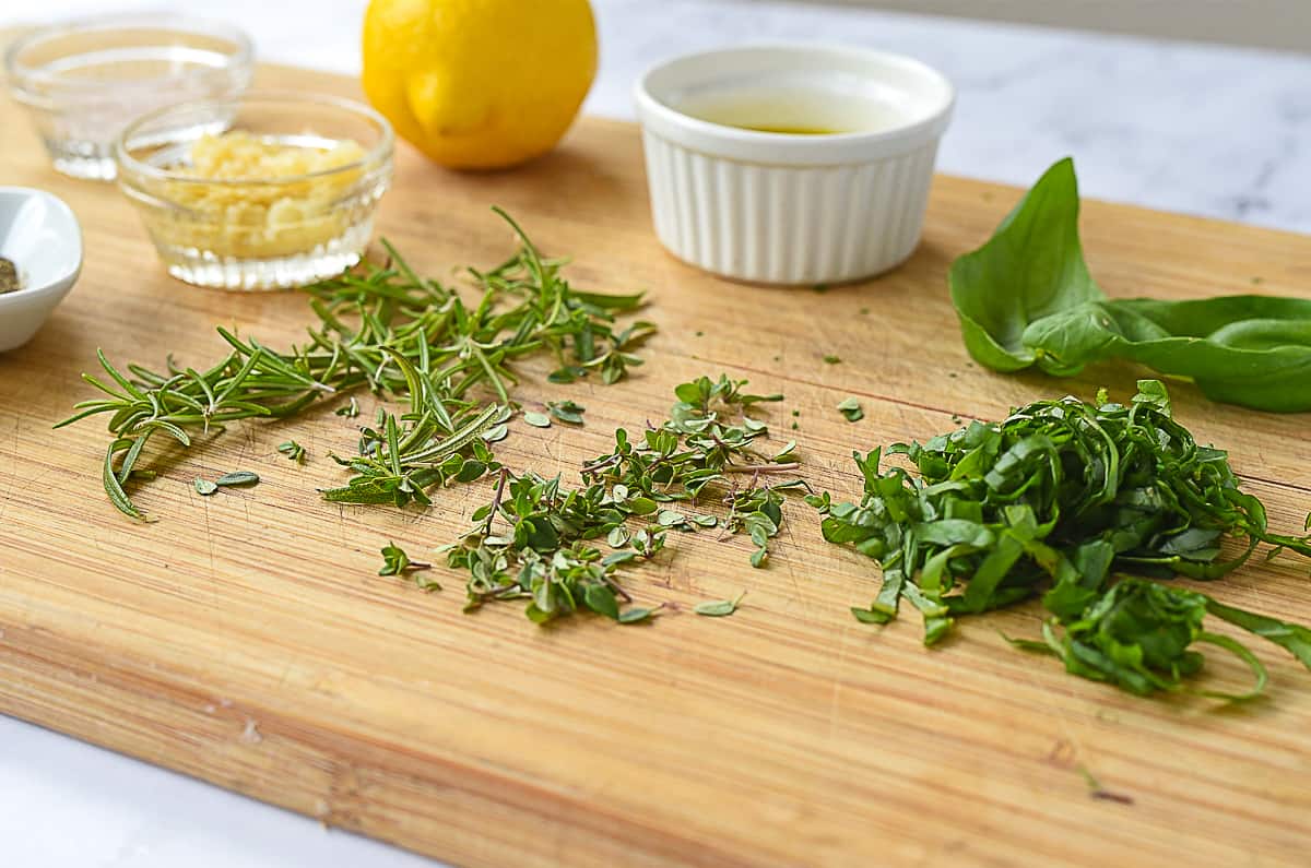 chopped herbs on a cutting board