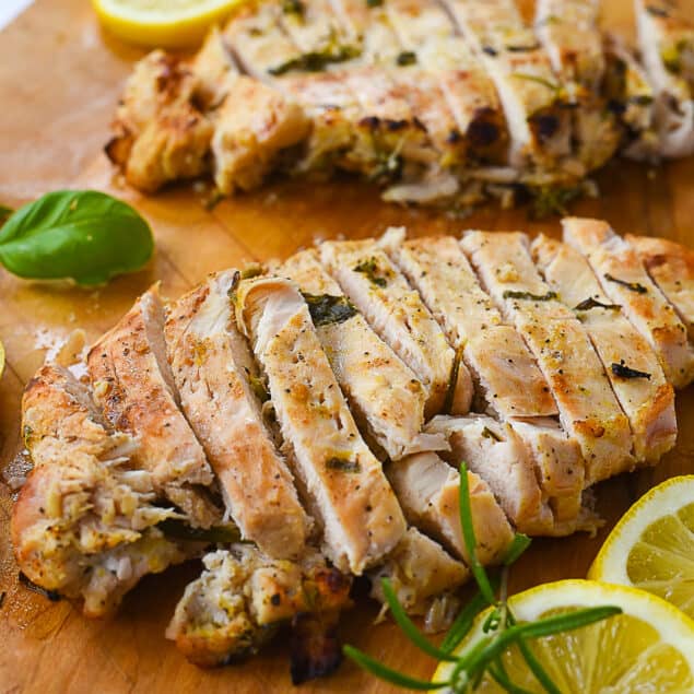 Two sliced chicken breasts on a cutting board